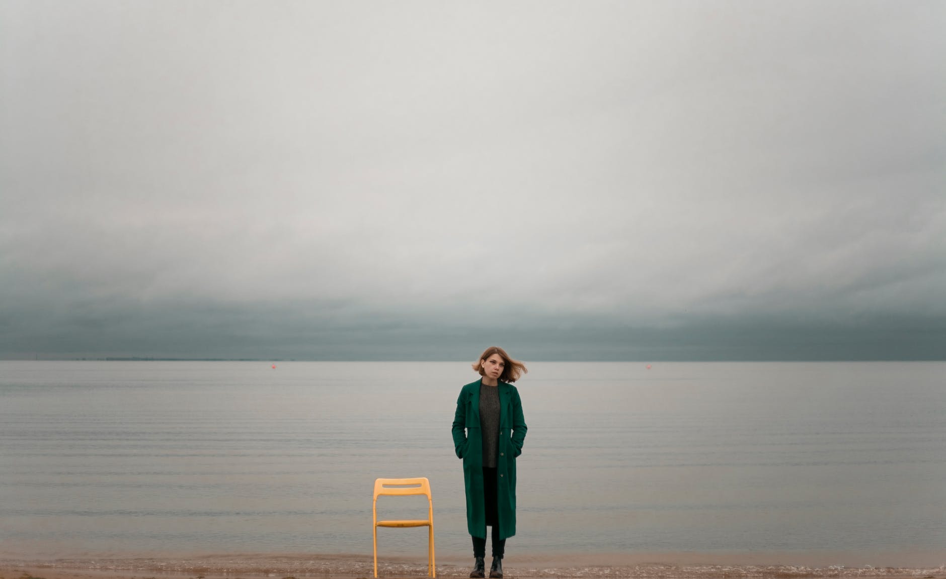 woman standing beside chair